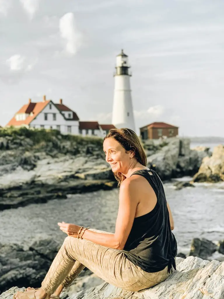 Annette sitting near the Portland Head Light