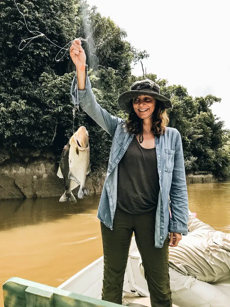 Annette showing a piranha she caught