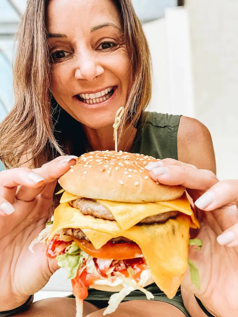 Annette eating a delectable cheeseburger