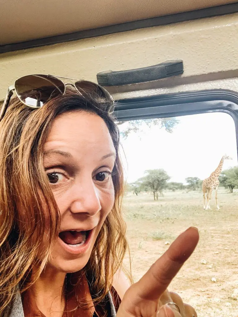 Annette pointing a Giraffe