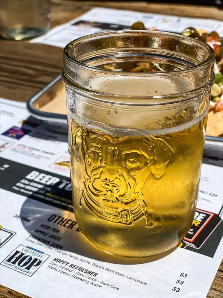 a beer in a glass jar with a dog on it at Lagunitas