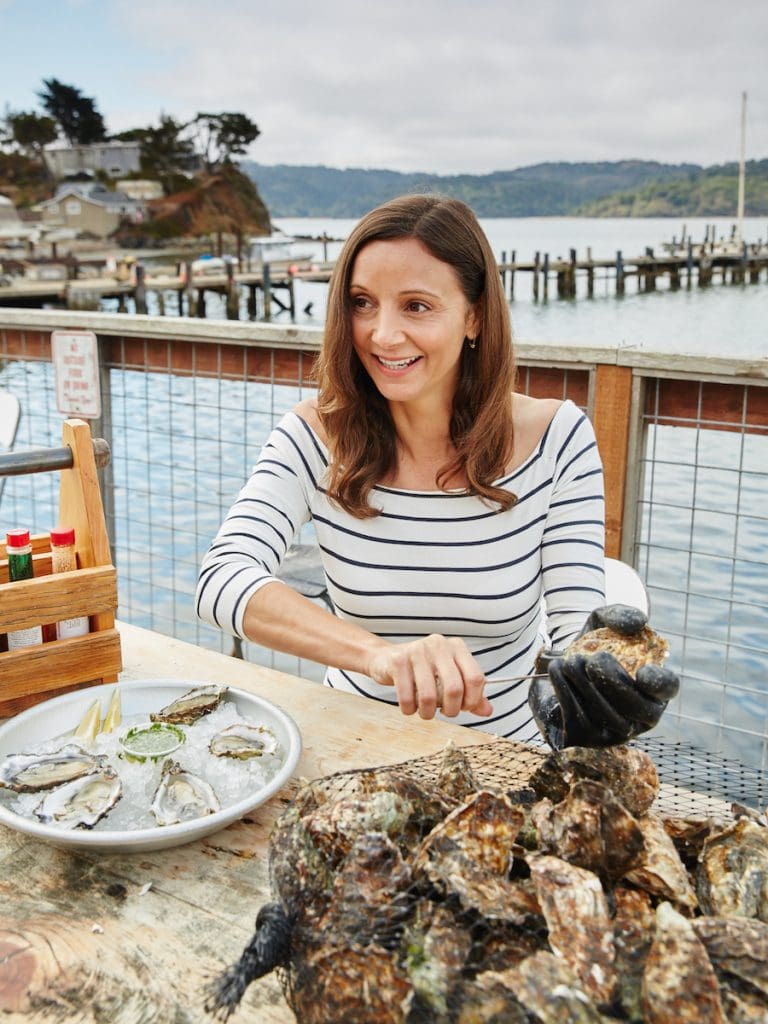 Annette White shucking Raw Oysters in Tomales