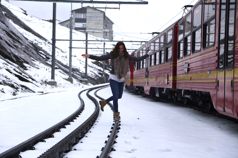 Annette White playing on the train tracks in Switzerland