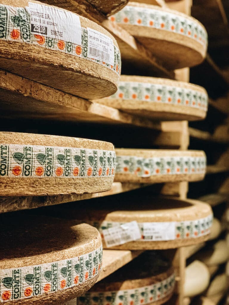 Wheels of Comte Cheese stacked and stored