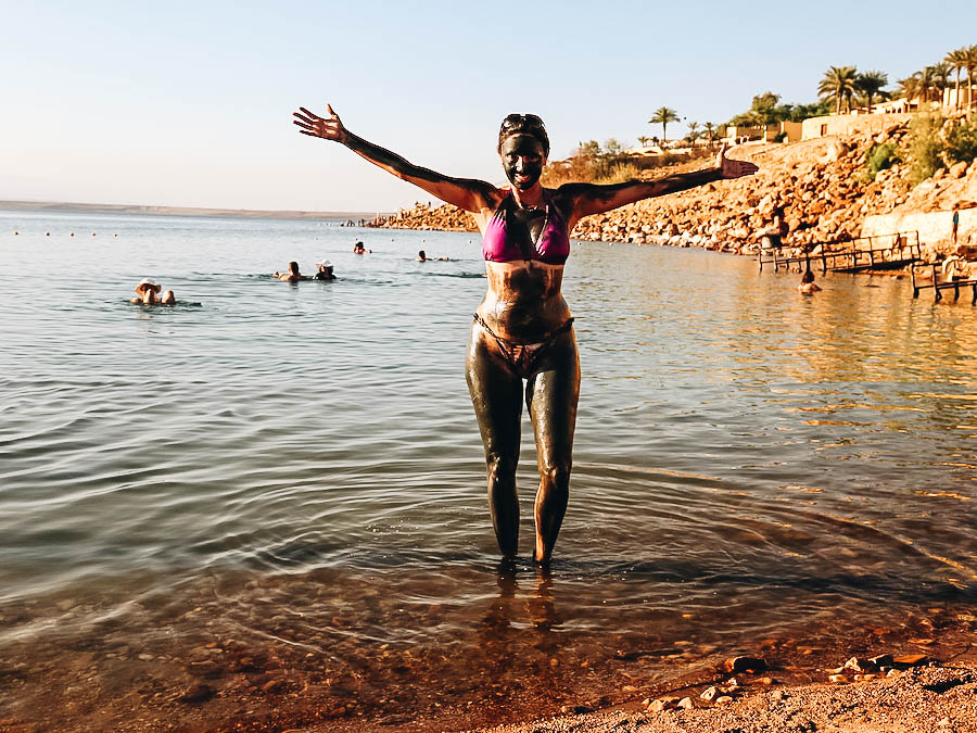 Annette wearing mud on her body before swimming to the Dead Sea.