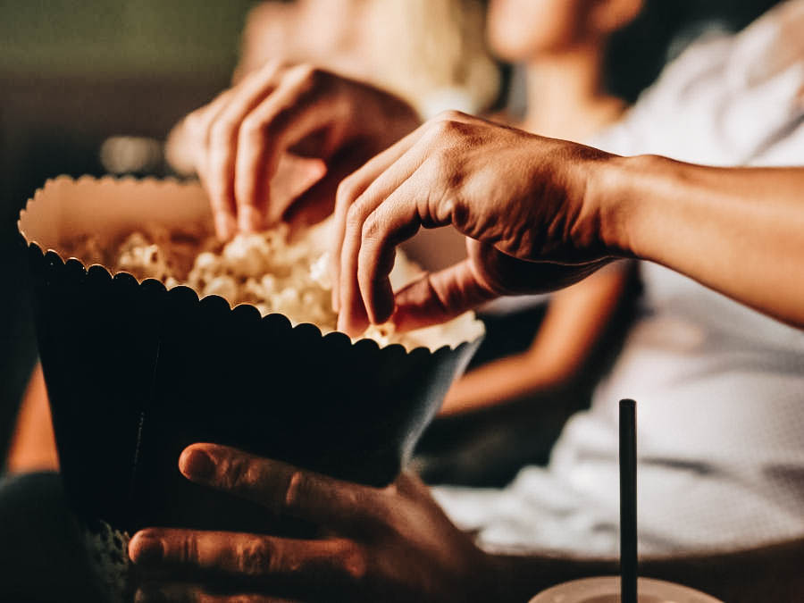 People eating popcorns while watching movie