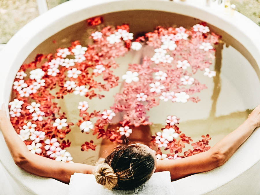 A woman relaxing on a flower bath